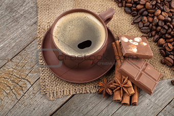 Coffee cup and spices on wooden table