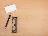 Blank business cards with pen and glasses