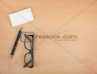 Blank business cards with pen and glasses