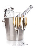 Two champagne glasses, bottle in bucket and alarm clock