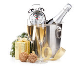 Christmas champagne with alarm clock in bucket and gift box