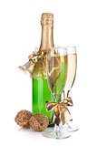 Champagne bottle, glasses and christmas decor
