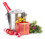 Champagne bottle in ice bucket, two empty glasses and christmas 