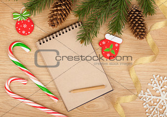 Christmas fir tree, blank notepad and decor