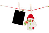 Blank photo frame and snowman hanging on the clothesline