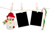 Blank photo frames and snowman hanging on the clothesline