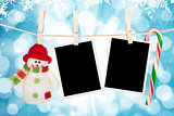 Blank photo frames and snowman hanging on the clothesline