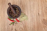 Mortar and pestle with red hot chili pepper and peppercorn