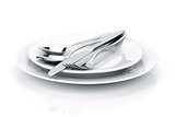 Silverware or flatware set of fork, spoons and knife on plates