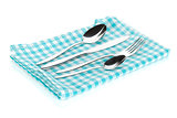 Silverware or flatware set of fork, spoons and knife on towel