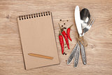 Blank notepad with pencil and silverware set