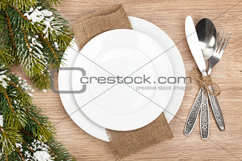 Empty plate, silverware set and christmas tree