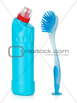 Plastic bottle of cleaning product and brush