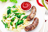 Fettuccine with vegetables and fried sausages