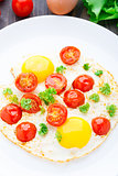Fried eggs with cherry tomatoes