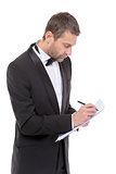 Handsome man in a bow tie writing notes