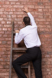 Man up against a brick wall