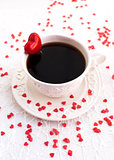 White cup of coffee decorated with red heart