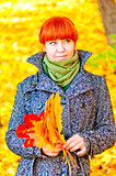 pretty woman with red hair with maple leaves