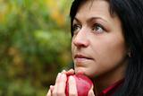 woman and apple in autumn park