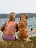 woman and dog on lake