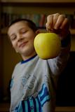 A child offers an apple