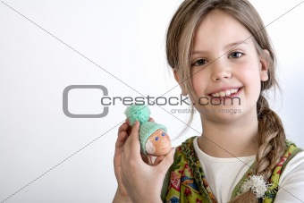 Young girl with painted egg with hat