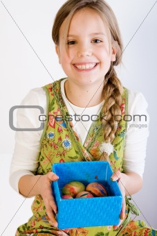 Young girl presenting a box with painted eggs