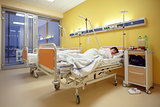 sad middle-aged woman lying in hospital