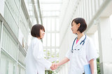 Asian medical doctors shaking hands 