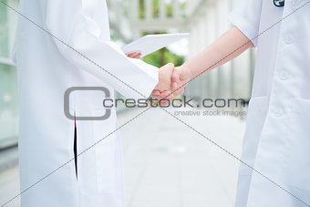 Medical doctors shaking hands