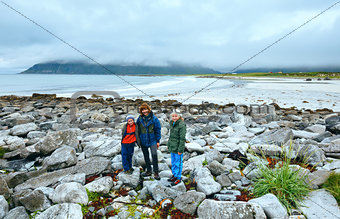 Family on summer Ramberg beach (Lofoten, Norway)
