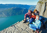 Happy family on  Preikestolen massive cliff top (Norway)