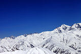 Winter snowy mountains and blue sky