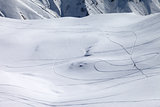 View on snowy off piste slope with trace from ski and snowboards