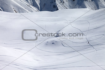 View on snowy off piste slope with trace from ski and snowboards