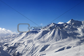 View on ski slope and beautiful mountains at sunny day