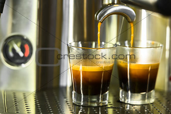 two shots of espresso being drawn