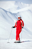 Female skier standing on mountain slope