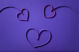 paper flowers with hearts on purple background