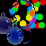 blue christmas balls and ribbons on a background lights in night