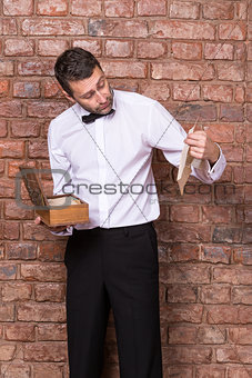 Man reading a document from a wooden box
