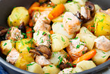 Baked salmon with potato, mushrooms and carrot