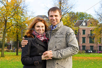 Outdoor happy couple in love posing in Museum Plein, autumn Amsterdam
