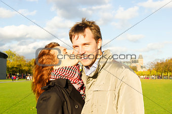 Outdoor happy couple kissing in Museumplein, Amsterdam
