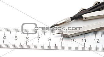 closeup  compasses and rulers on a white paper.