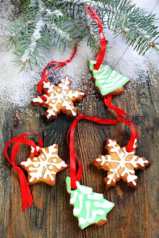 Christmas cookies and spruce branches in the snow.