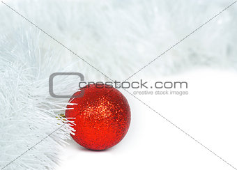 Red  ball and white Christmas tinsel