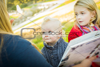 Mother Reading a Book to Her Two Adorable Blonde Children 