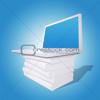 Laptop on a pile of white books